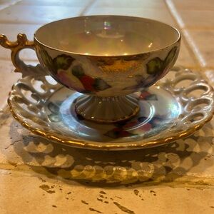 China irredescant glass hand painted tea cup and saucer